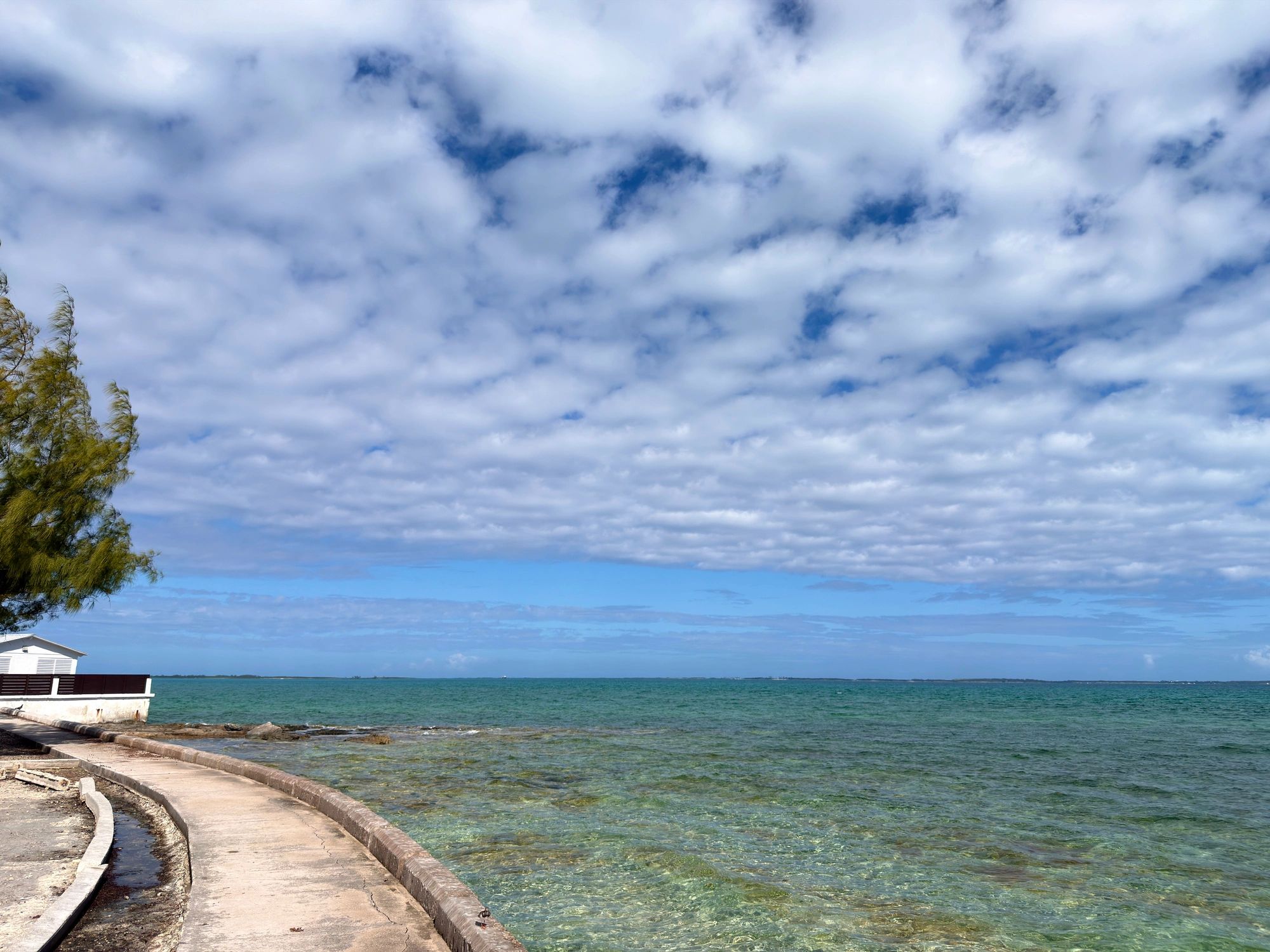 Coastal path beside bright blue ocean water