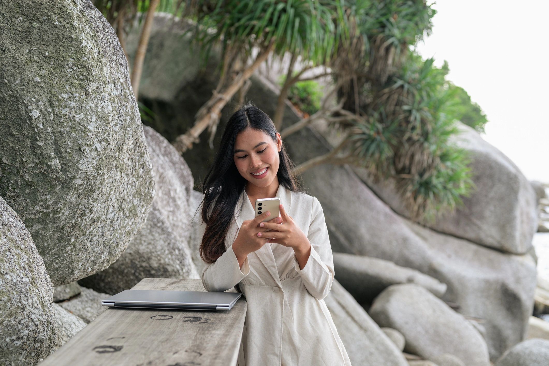 Beach visitor using mobile phone near the coast